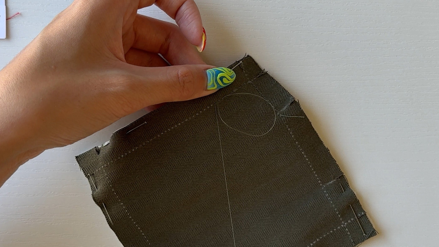 Action shot of hand sewing a fabric coaster